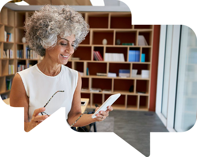 Business woman looking at her smartphone and smiling.